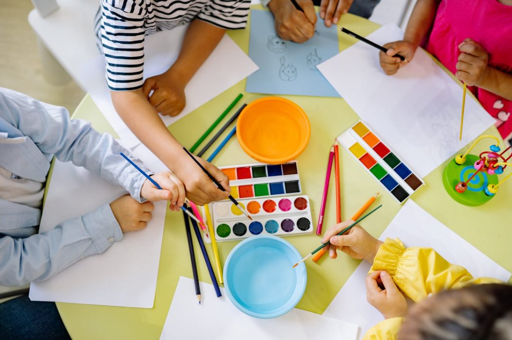group of children doing painting with water color