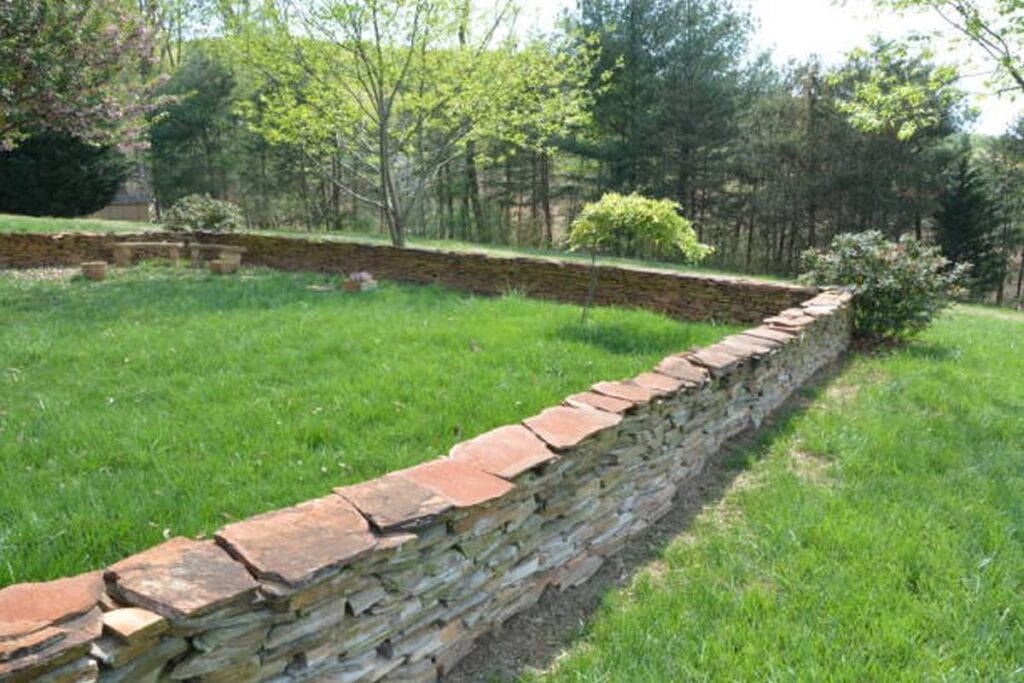 a stone slate fence marking a small garden.
